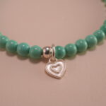 Close-up of turquoise, agate beads, and heart charm