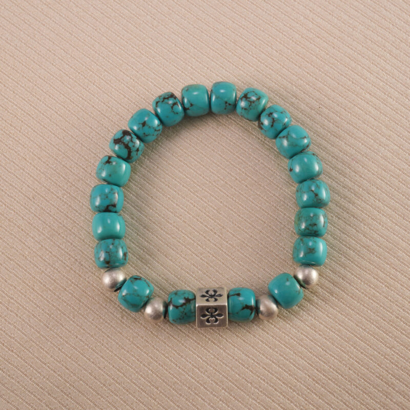 Close-up of an 8mm turquoise gemstone birthstone bracelet on white background