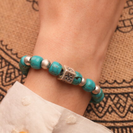 Model wearing turquoise 8mm gemstone bracelet, styled with minimal jewelry