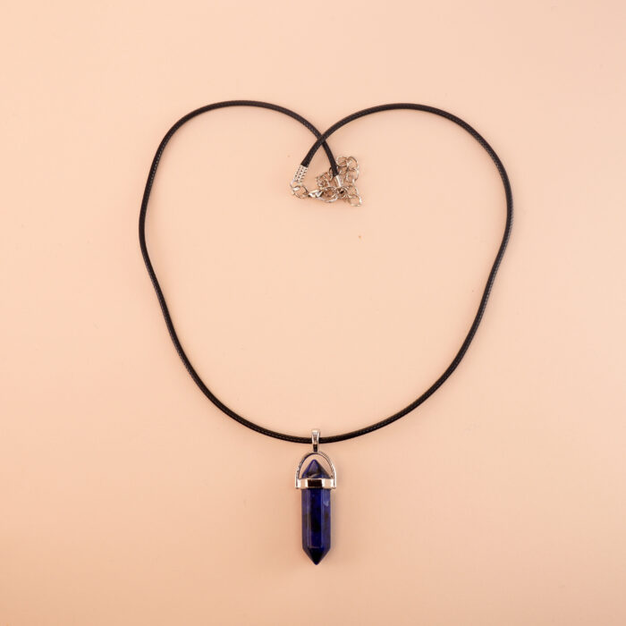 Handmade natural lapis lazuli point pendant on neutral or dark background