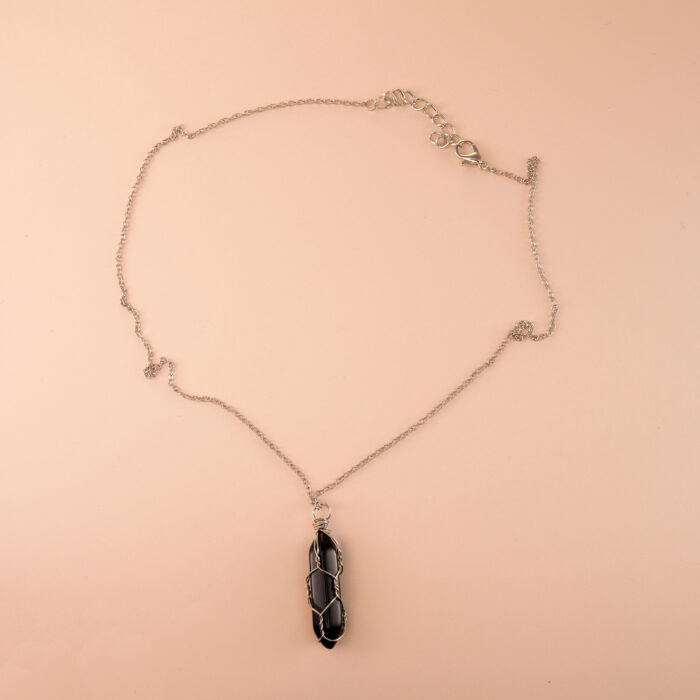 Handmade black obsidian point pendant necklace on white background