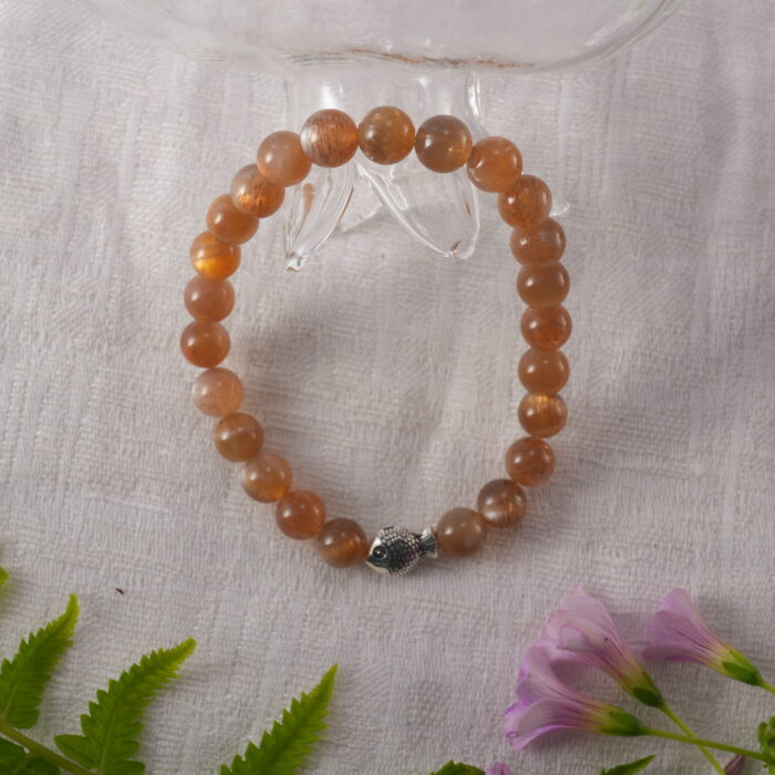 Moonstone bracelet placed beside calming objects, symbolizing emotional healing