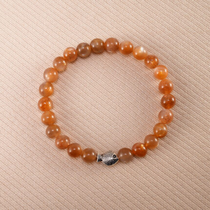 Peach Moonstone bracelet with silver fish charm, featuring soft 6mm beads