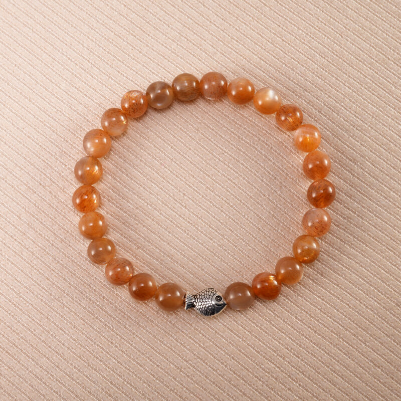 Peach Moonstone bracelet with silver fish charm, featuring soft 6mm beads