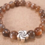 Close-up of glowing sunstone beads and silver detailing