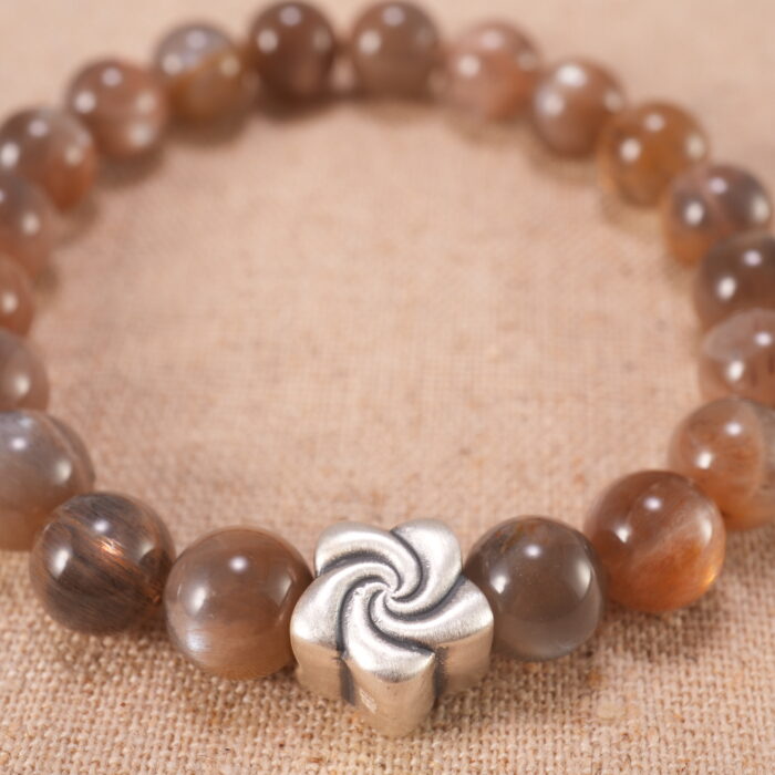 Close-up of glowing sunstone beads and silver detailing