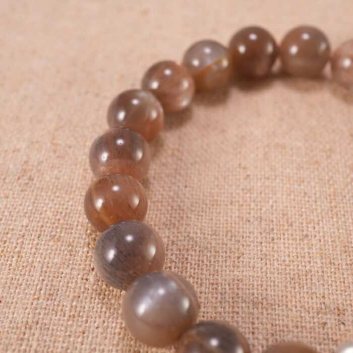 Close-up of glowing sunstone beads and silver detailing