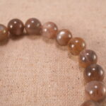 Close-up of glowing sunstone beads and silver detailing