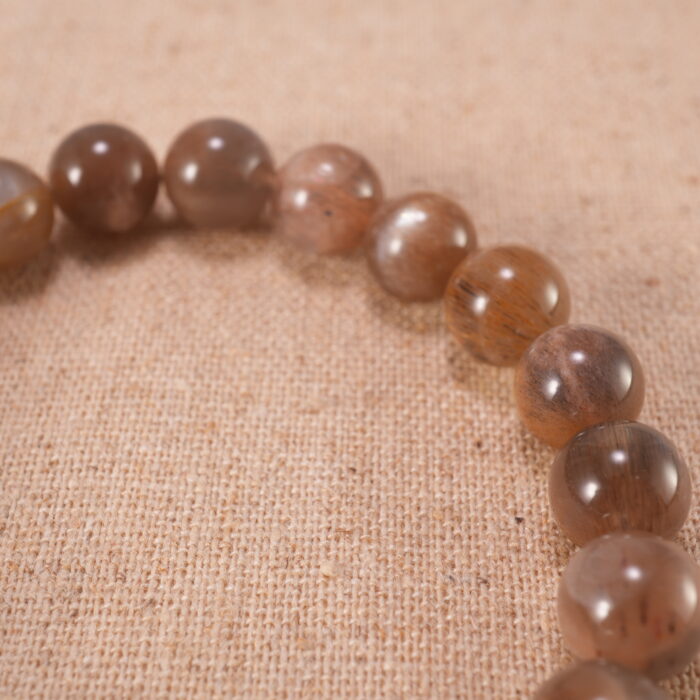 Close-up of glowing sunstone beads and silver detailing