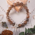 Bracelet placed on soft linen under warm sunlight, evoking calm and strength
