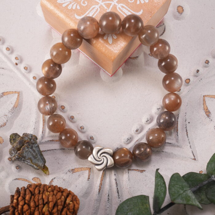 Bracelet placed on soft linen under warm sunlight, evoking calm and strength