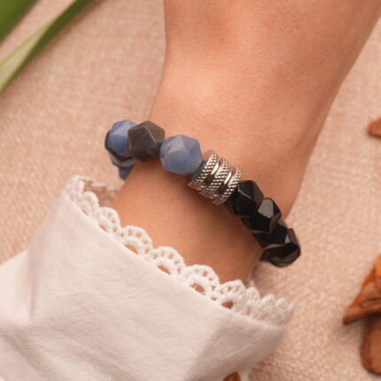 Bracelet worn on a man's wrist, styled with casual wear to reflect strength and simplicity.