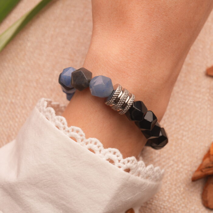 Bracelet worn on a man's wrist, styled with casual wear to reflect strength and simplicity.