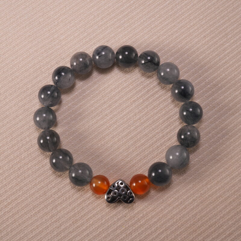 Gray rutile agate and rutile quartz 10mm protection bracelet with silver clasp on neutral background.