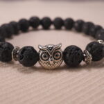 Close-up of lava bead texture and owl charm detail.