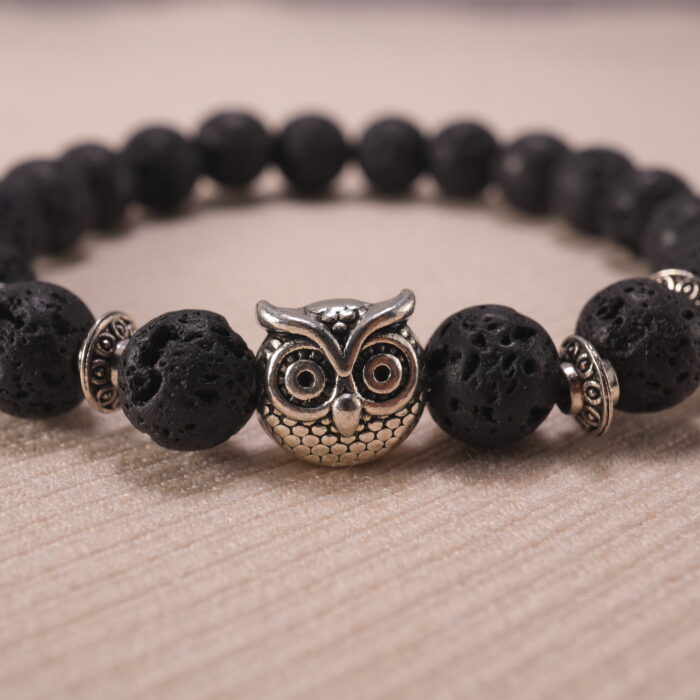 Close-up of lava bead texture and owl charm detail.