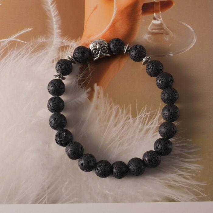 Bracelet displayed on natural stone and wood elements, evoking grounding energy.