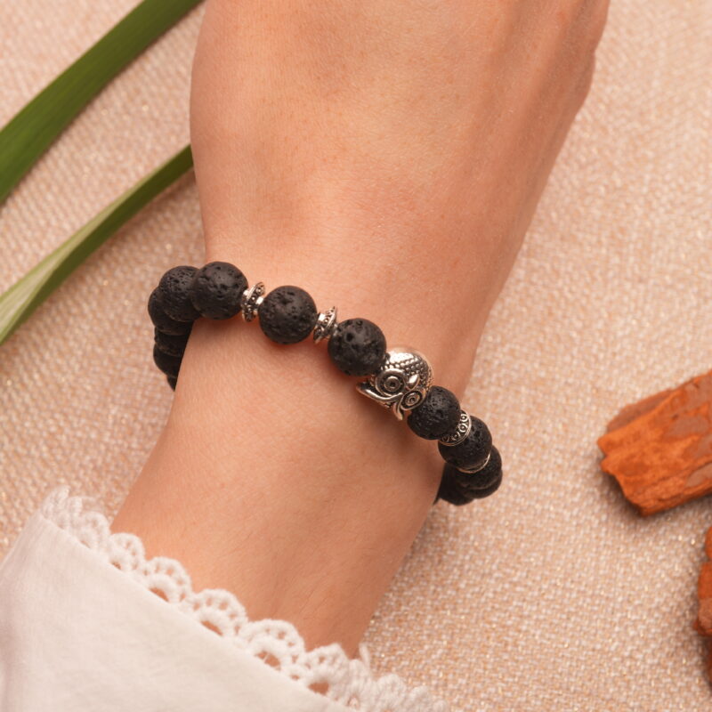 Bracelet worn on a wrist, showing the charm and bead fit in casual, everyday style.