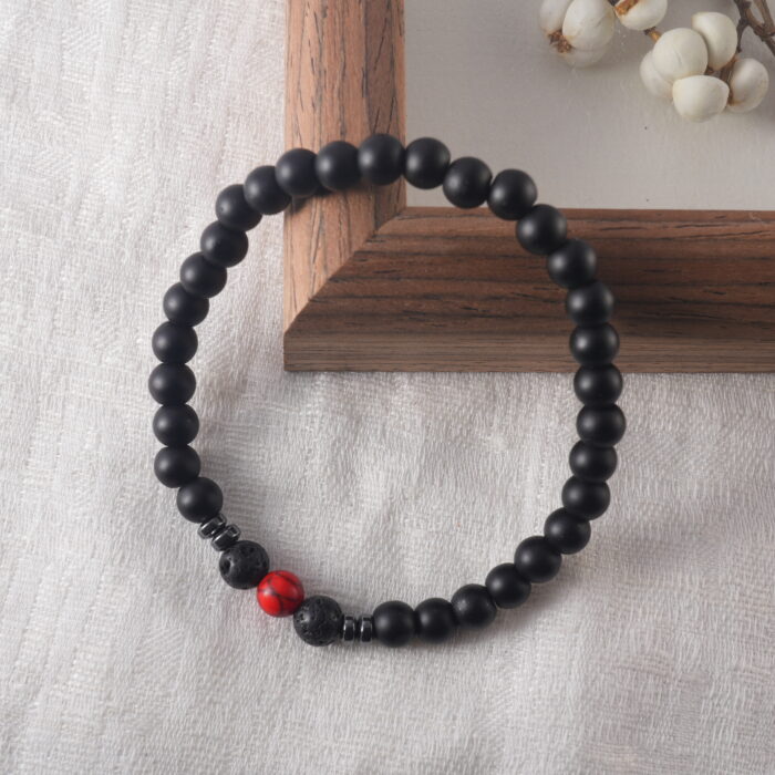 Bracelet resting on natural wood surface under soft natural light, evoking protection and energy