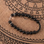 Bracelet placed on soft fabric in natural light, symbolizing clarity and calm