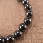 Close-up of natural stone beads with silver accents and smooth finish