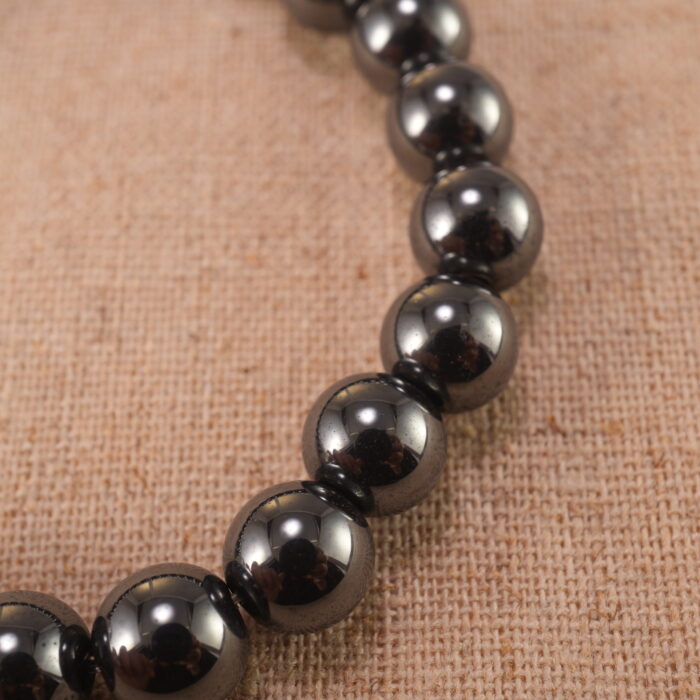 Close-up of natural stone beads with silver accents and smooth finish