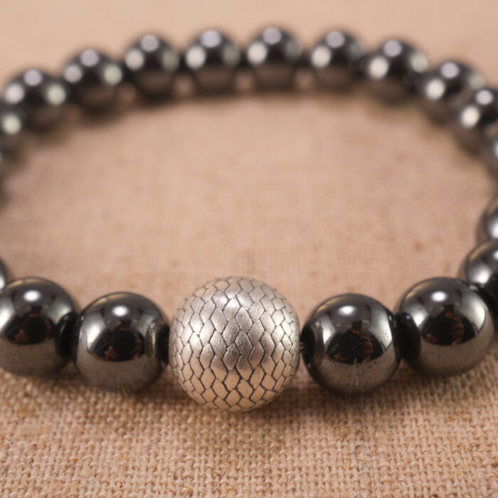 Close-up of natural stone beads with silver accents and smooth finish