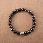Hematite, aventurine, and black tourmaline bracelet on white background