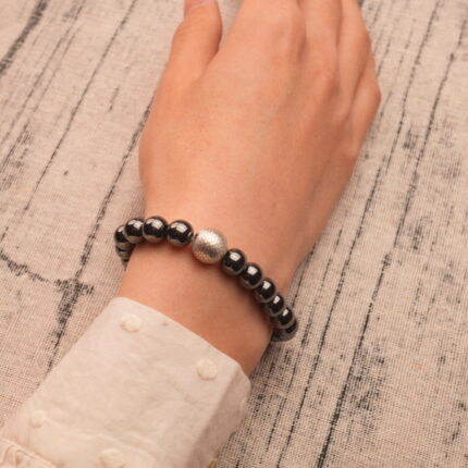 Bracelet worn on wrist with neutral clothing, showing minimalist daily style
