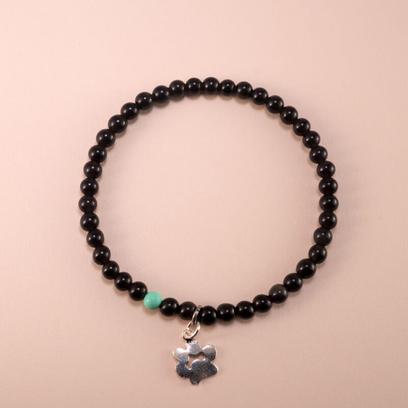 Obsidian and turquoise 4mm bracelet with gold clasp and silver charm displayed on white background