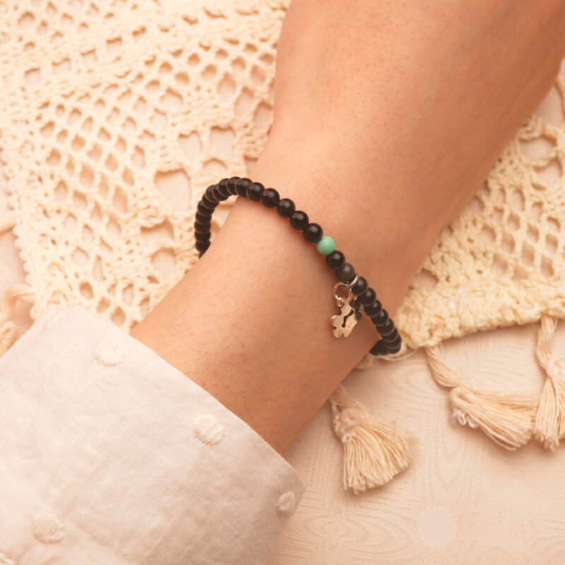 Person wearing the bracelet on wrist, showcasing its elegant and minimal 4mm design
