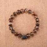 Phantom Quartz gemstone heart bracelet with 8mm beads and silver clasp on white background