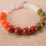 Close-up of pink, red, and white gemstone beads with soft shine