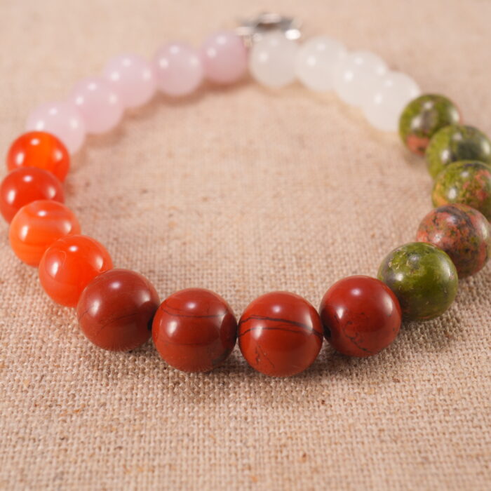 Close-up of pink, red, and white gemstone beads with soft shine