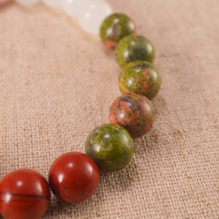 Close-up of pink, red, and white gemstone beads with soft shine