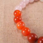Close-up of pink, red, and white gemstone beads with soft shine