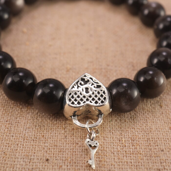 Close-up of polished obsidian beads and sterling silver clasp