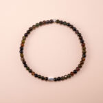 Black tourmaline 4mm bracelet with elastic cord displayed on a neutral background