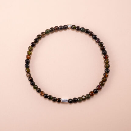 Black tourmaline 4mm bracelet with elastic cord displayed on a neutral background
