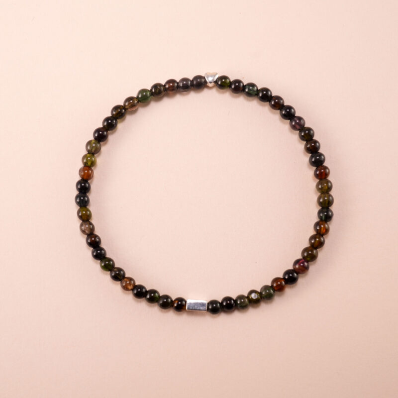 Black tourmaline 4mm bracelet with elastic cord displayed on a neutral background