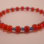 Close-up of 4mm red agate and blue apatite beads on energy bracelet