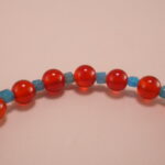 Close-up of 4mm red agate and blue apatite beads on energy bracelet