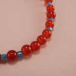 Close-up of 4mm red agate and blue apatite beads on energy bracelet