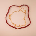Handmade red agate round bead necklace neatly laid on a light background