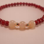 Hand wearing red agate and white chalcedony bracelet – simple gemstone jewelry for everyday wear