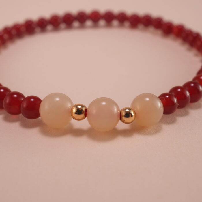 Hand wearing red agate and white chalcedony bracelet – simple gemstone jewelry for everyday wear