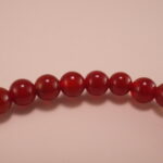 Hand wearing red agate and white chalcedony bracelet – simple gemstone jewelry for everyday wear