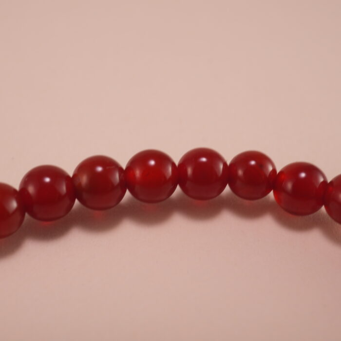 Hand wearing red agate and white chalcedony bracelet – simple gemstone jewelry for everyday wear