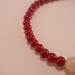 Hand wearing red agate and white chalcedony bracelet – simple gemstone jewelry for everyday wear