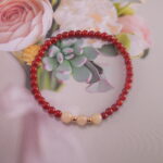 Red agate and chalcedony bracelet styled near flowers and crystals – calming energy scene